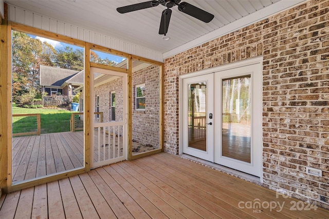 unfurnished sunroom featuring french doors and ceiling fan