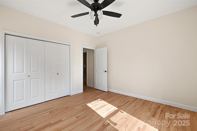 unfurnished bedroom featuring a closet, ceiling fan, and light wood-type flooring