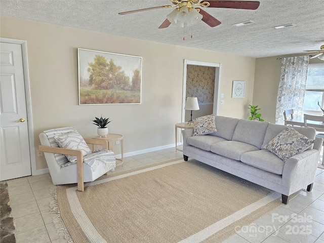 tiled living room with a textured ceiling and ceiling fan