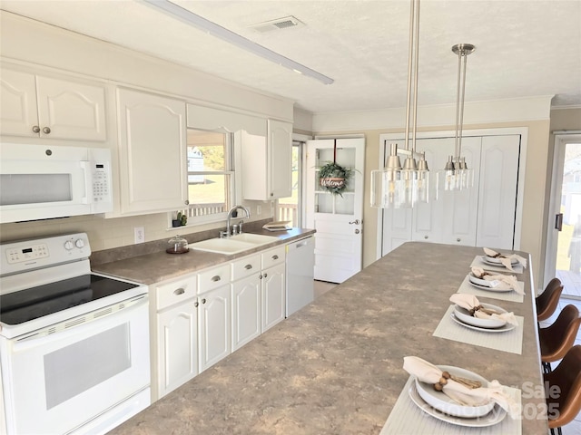 kitchen featuring white cabinets, sink, white appliances, and pendant lighting