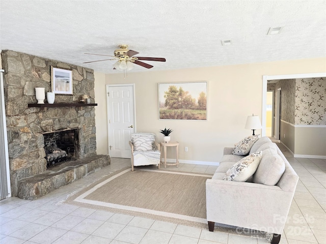 unfurnished living room with a textured ceiling, light tile patterned flooring, and a stone fireplace