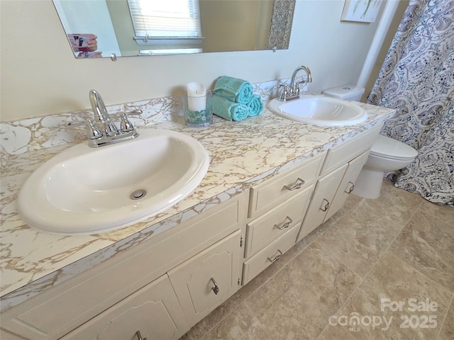 bathroom with toilet and vanity