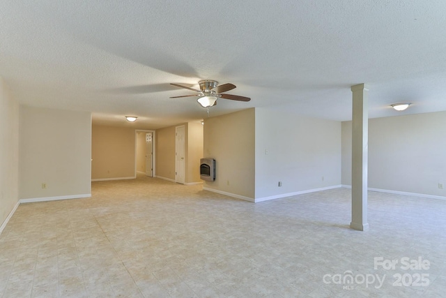 unfurnished living room featuring ceiling fan, a wood stove, and heating unit