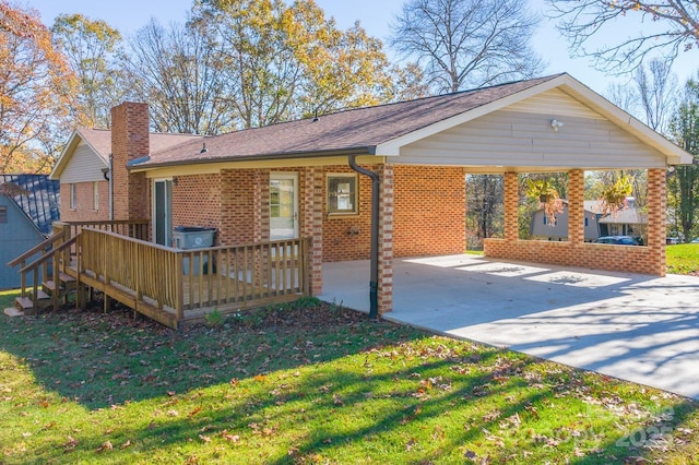 exterior space featuring a deck and a lawn