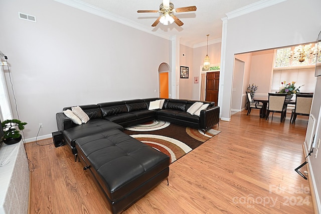 living room with hardwood / wood-style floors, ceiling fan, and crown molding