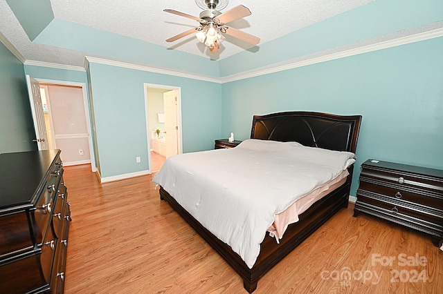 bedroom with a textured ceiling, light wood-type flooring, and ceiling fan