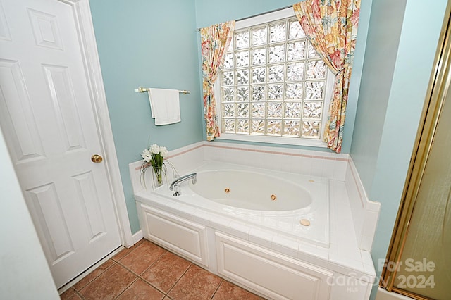 bathroom with tile patterned floors and a tub