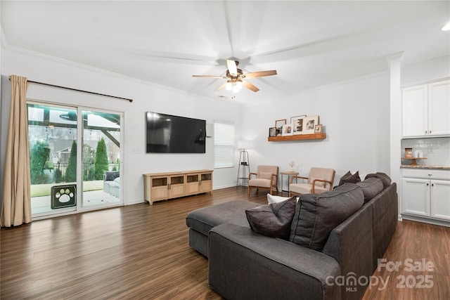 living room featuring ornamental molding, dark hardwood / wood-style flooring, and plenty of natural light