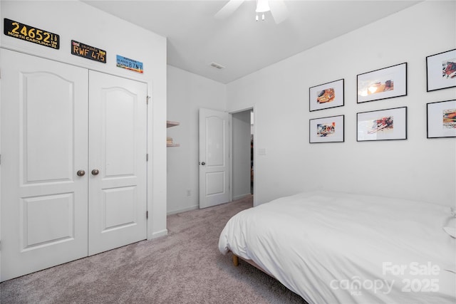 bedroom featuring ceiling fan, a closet, and light carpet