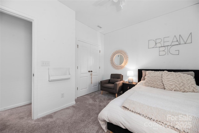 carpeted bedroom with a closet and ceiling fan