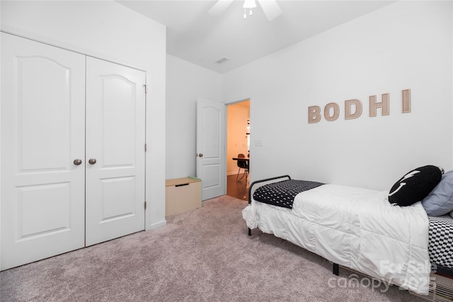 bedroom with ceiling fan, a closet, and carpet floors