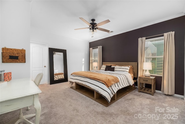 bedroom featuring ceiling fan, ornamental molding, and light carpet