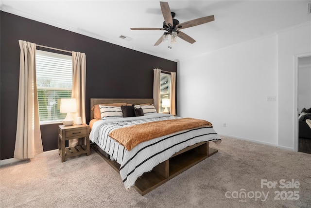 carpeted bedroom featuring multiple windows, ceiling fan, and ornamental molding