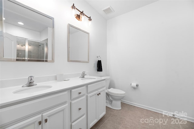 bathroom featuring toilet, a shower with door, vanity, and tile patterned flooring