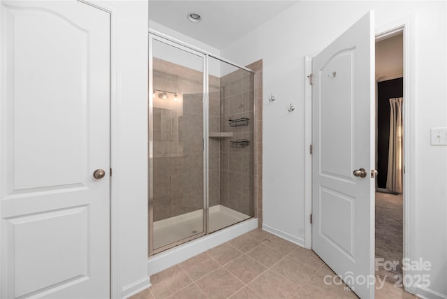 bathroom featuring an enclosed shower and tile patterned floors