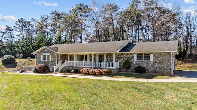 ranch-style house with covered porch and a front yard