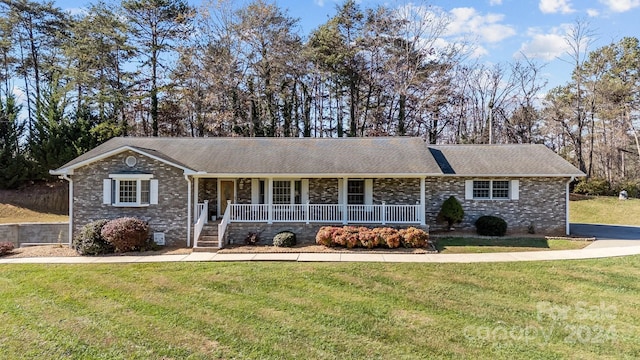 ranch-style home featuring a porch and a front lawn