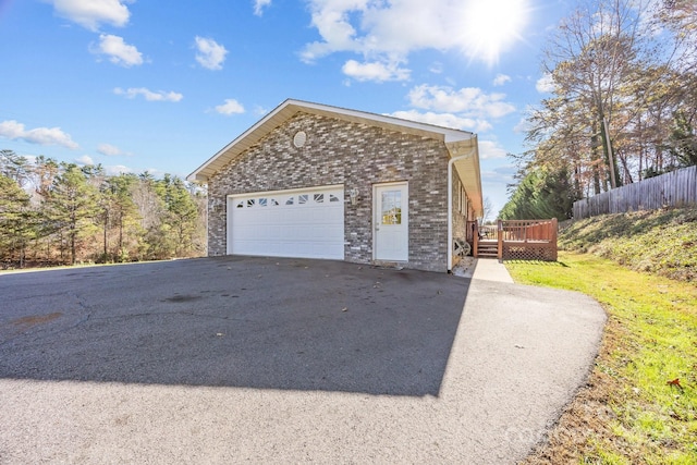 view of property exterior with a deck and a garage