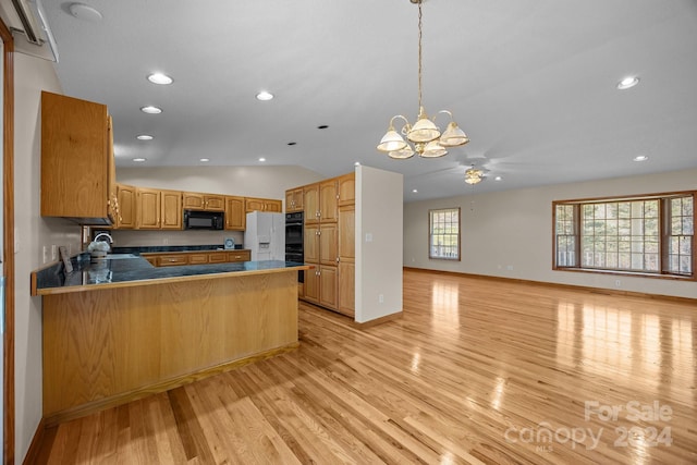 kitchen with kitchen peninsula, light hardwood / wood-style floors, decorative light fixtures, vaulted ceiling, and black appliances