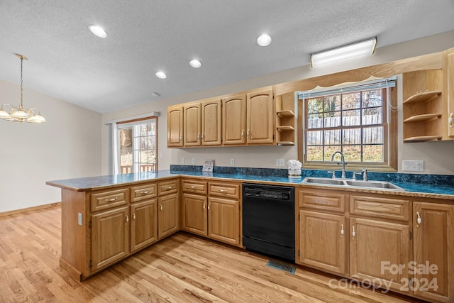 kitchen featuring sink, decorative light fixtures, an inviting chandelier, black dishwasher, and light hardwood / wood-style floors