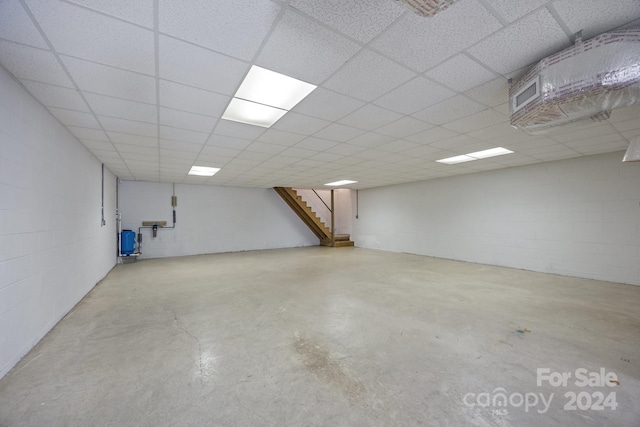 basement with a paneled ceiling