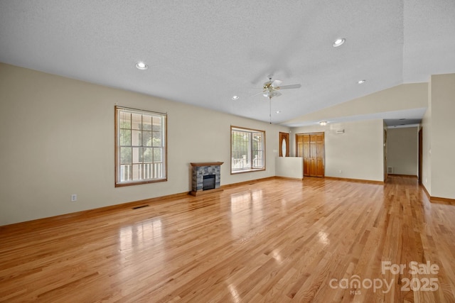 unfurnished living room with a textured ceiling, ceiling fan, recessed lighting, and light wood-type flooring