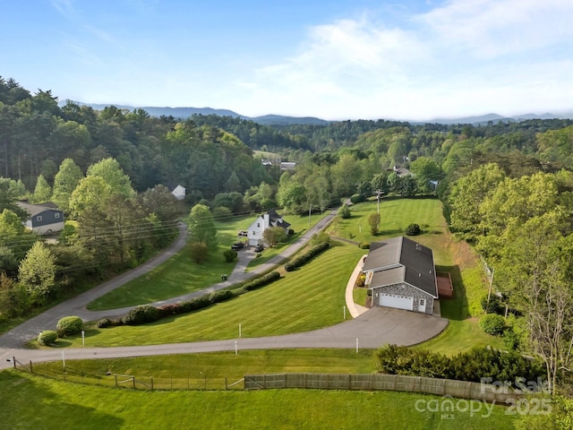 birds eye view of property featuring a view of trees and a rural view