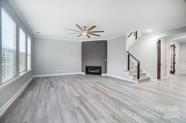 unfurnished living room with light hardwood / wood-style floors, ceiling fan, and crown molding