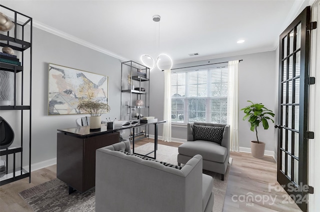 home office featuring crown molding and light hardwood / wood-style floors