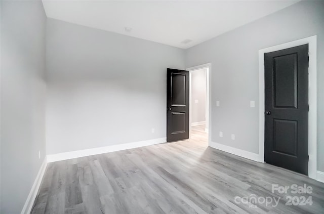 empty room with light hardwood / wood-style flooring