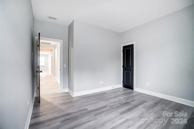 spare room with light hardwood / wood-style flooring