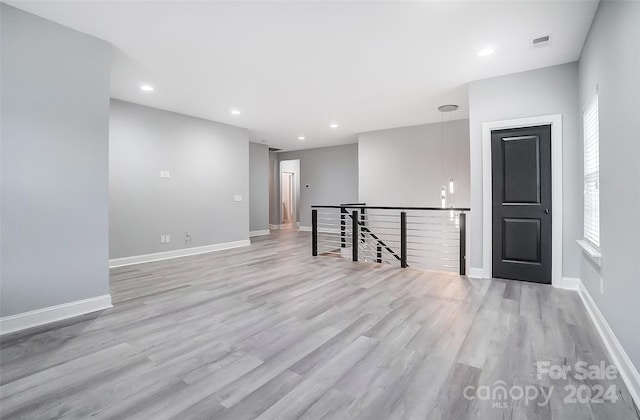 empty room with light hardwood / wood-style floors