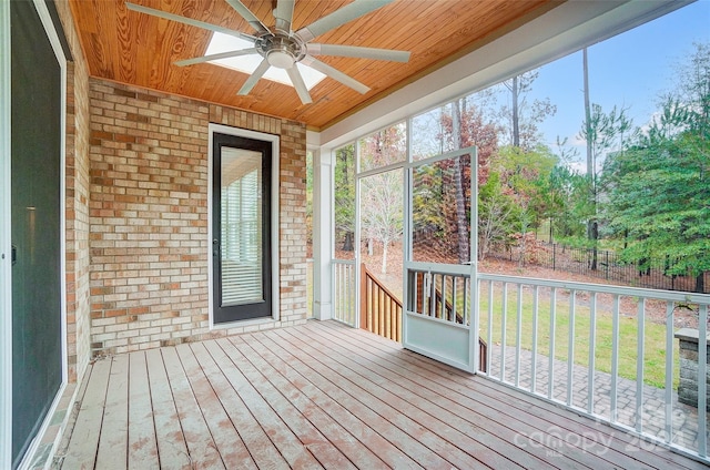 unfurnished sunroom with ceiling fan and wooden ceiling