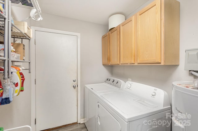 laundry area with cabinet space, light wood-style flooring, and separate washer and dryer