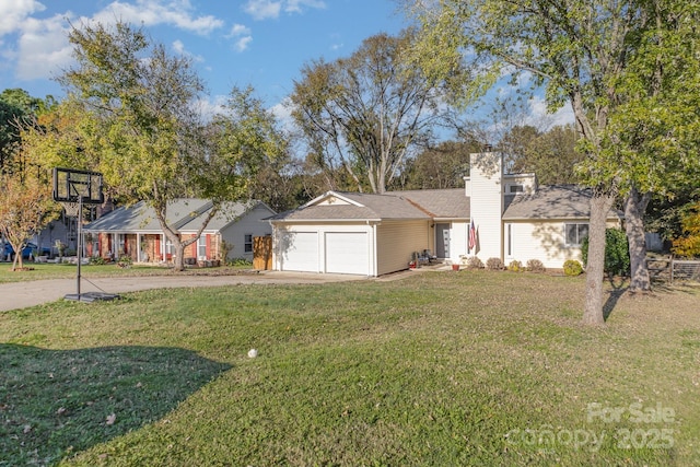 view of front of home featuring a chimney, a front lawn, an attached garage, and driveway