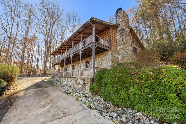 view of side of property featuring a balcony