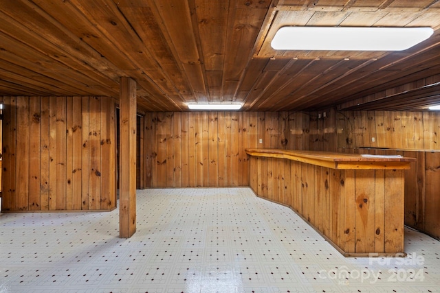 bar featuring wooden ceiling and wooden walls