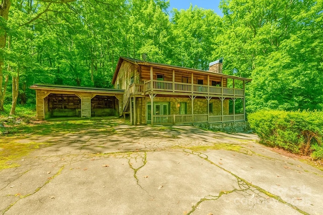 71 Blue Grass Cir, Rosman, NC 28772 - view of front of property featuring a chimney, stone siding, driveway, and covered porch