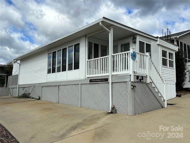 view of property exterior featuring a porch