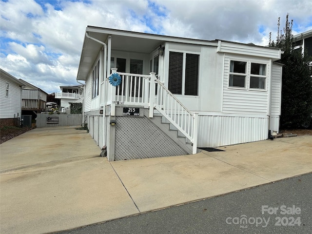 manufactured / mobile home with covered porch and central AC unit