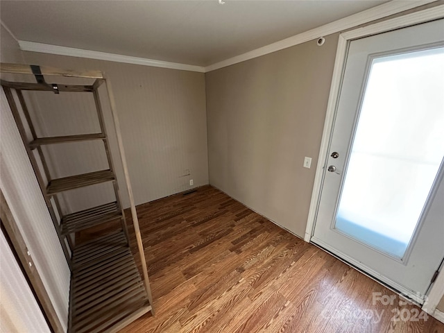 interior space with hardwood / wood-style floors and crown molding