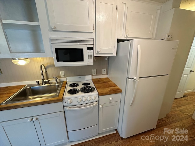 kitchen with white appliances, butcher block countertops, and white cabinetry