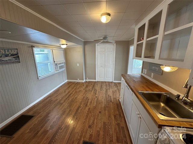 bar featuring sink, ornamental molding, butcher block countertops, dark hardwood / wood-style flooring, and white cabinetry