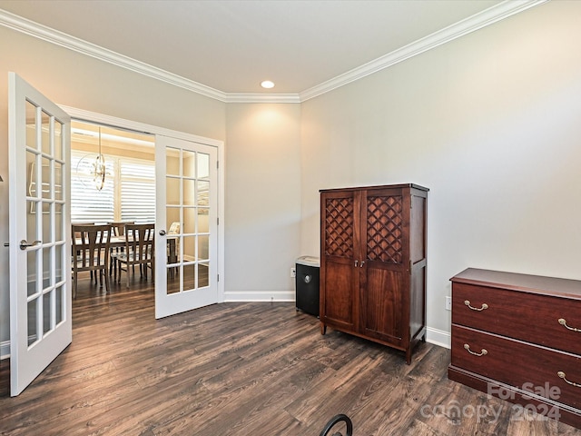 interior space with a chandelier, ornamental molding, dark wood-type flooring, and french doors