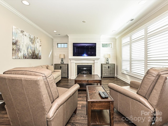 living room featuring a tile fireplace, dark hardwood / wood-style floors, and ornamental molding