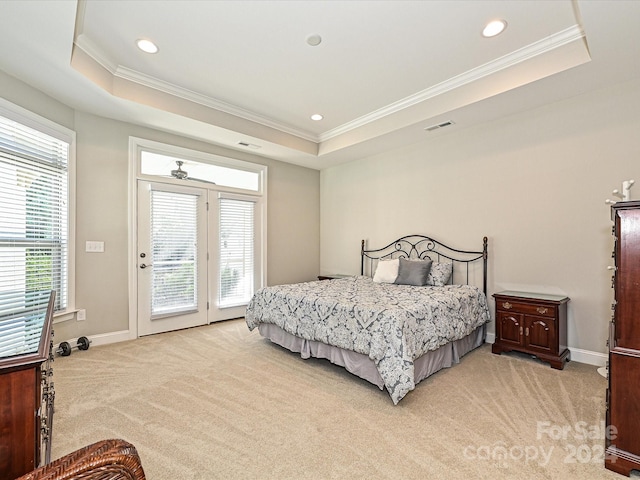 carpeted bedroom featuring access to exterior, a raised ceiling, and ornamental molding