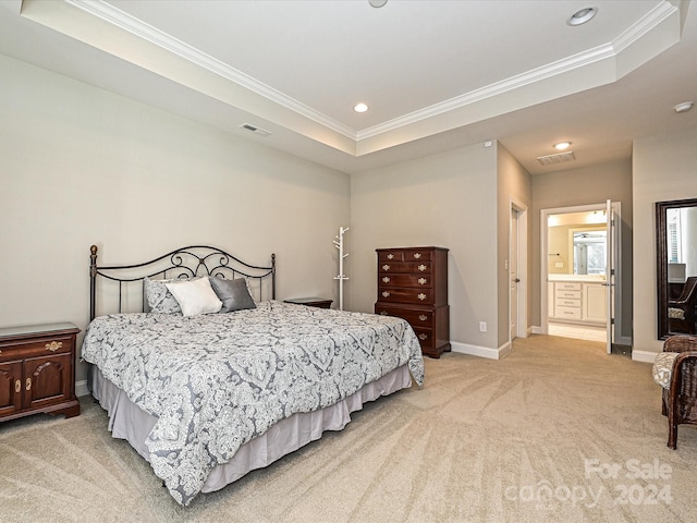 carpeted bedroom featuring a raised ceiling, ensuite bathroom, and crown molding