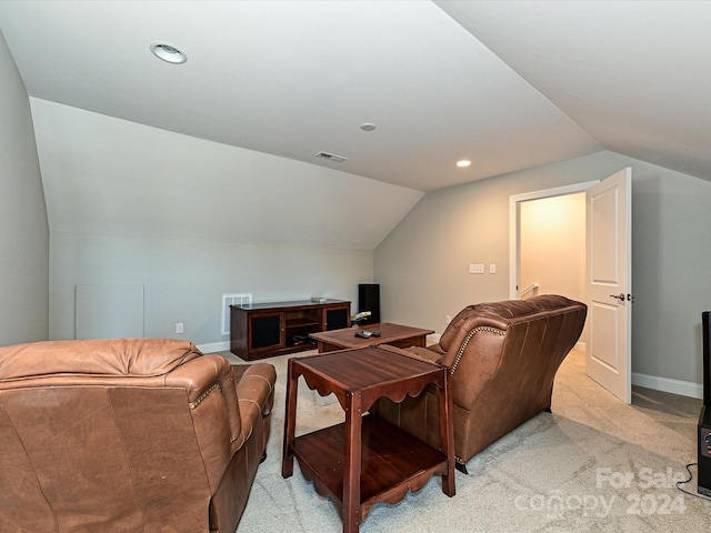 home theater with light colored carpet and vaulted ceiling