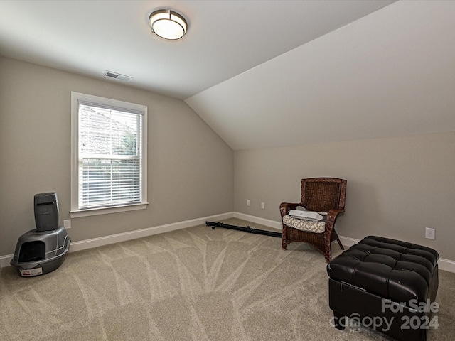 sitting room featuring carpet and lofted ceiling