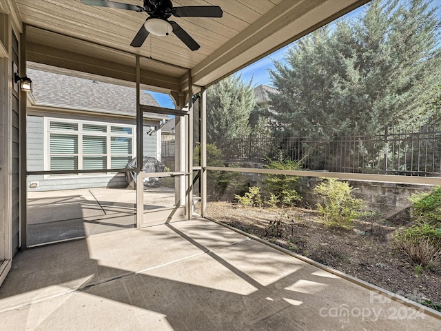 unfurnished sunroom with ceiling fan